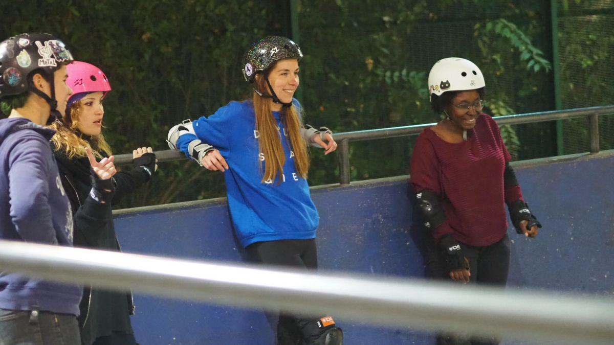 Quatre patineuses du Roller Coven attendent leur tour à la petite rampe du skate park.